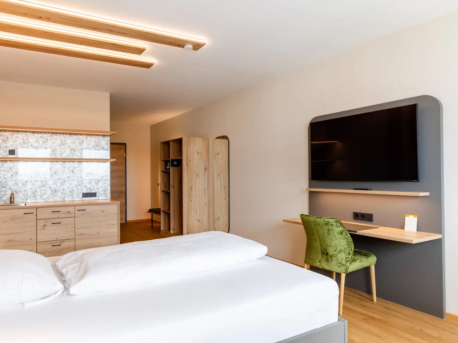 Suite mit großem Bett, Fernseher und Schreibtisch